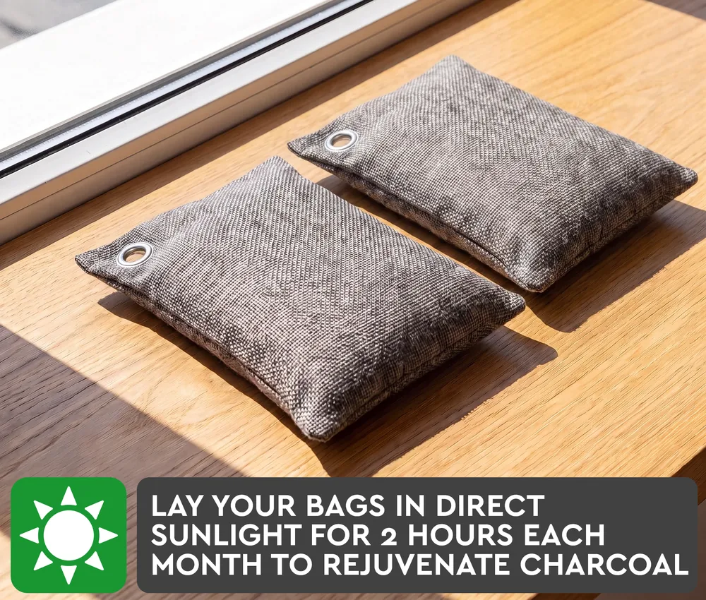 Two charcoal bags lying in direct sunlight on a windowsill, with the instruction to lay the bags in direct sunlight for 2 hours each month